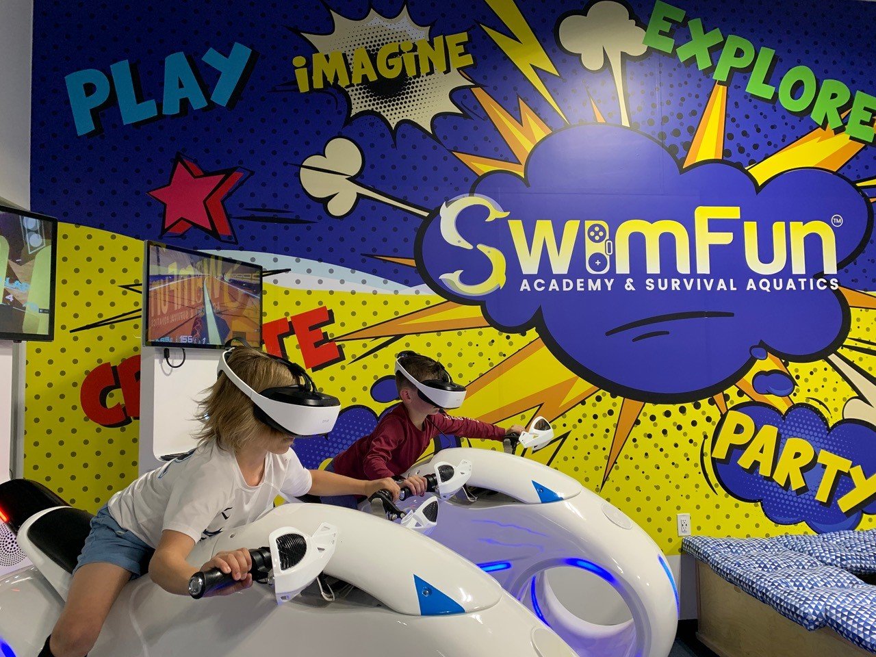 Children play a virtual reality game at SwimFun, which offers a unique approach of combining a modernized survival aquatics and swim academy with STEM-based activities.